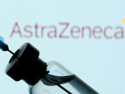 A vial and syringe in front of an AstraZeneca logo in this illustration taken January 11, 2021.