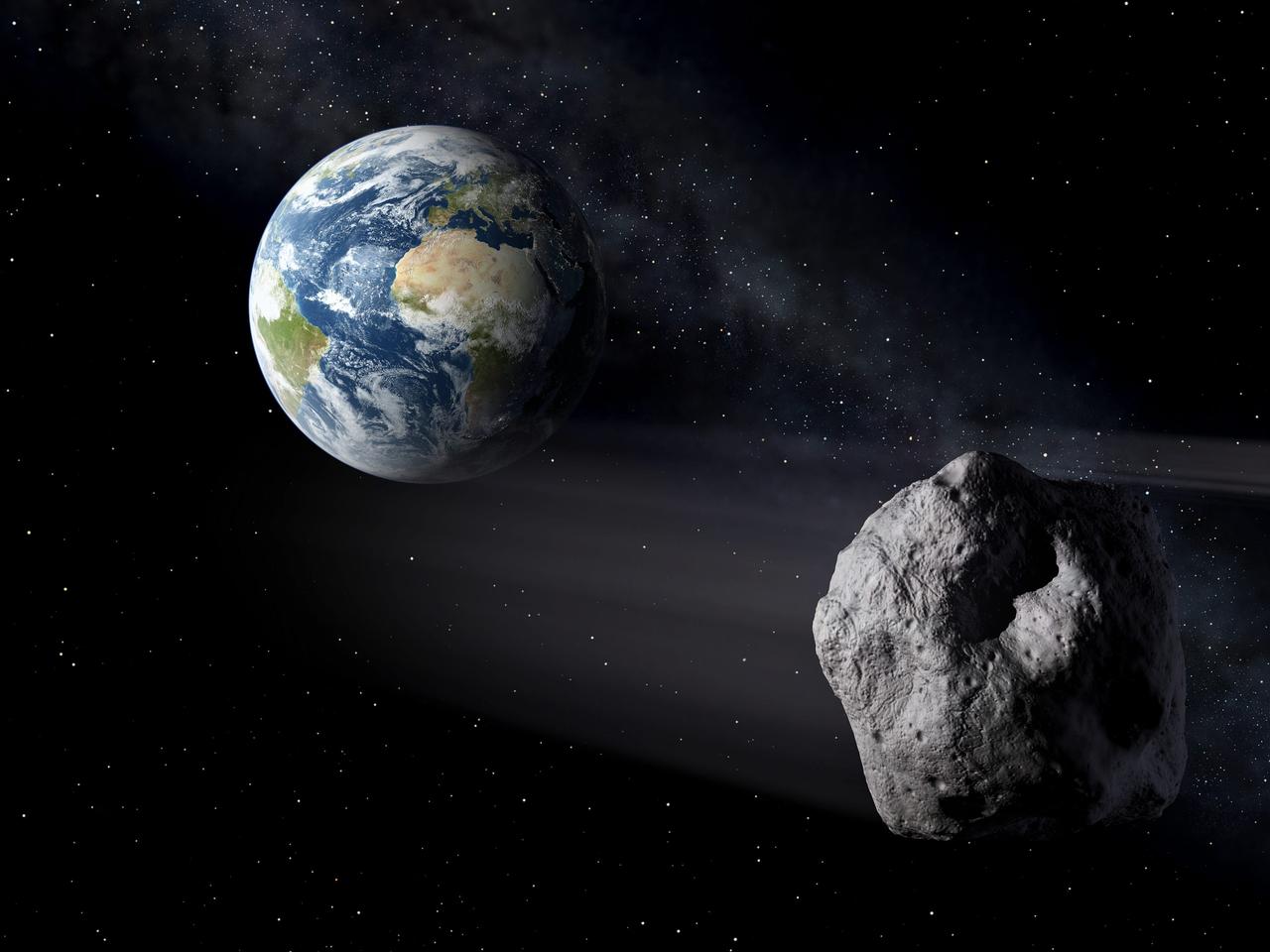 地球に接近する小惑星の想像図。