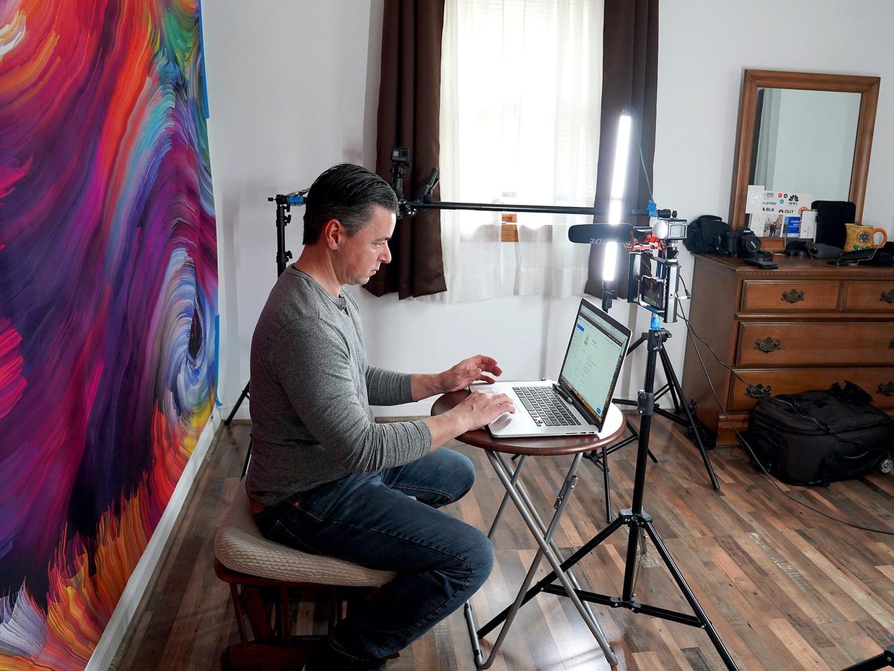 A video producer works from his at-home studio to conduct remote interviews with talent on April 19, 2020 in Franklin Square, New York.