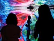レフィーク・アナドール（Refik Anadol）によるインスタレーション作品｢Machine Hallucinations - Space: Metaverse｣を鑑賞する人々。