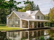 The house, located in Eldred, New York, is known as the "floating farmhouse" due to its cantilevered porch, which hangs over a stream.