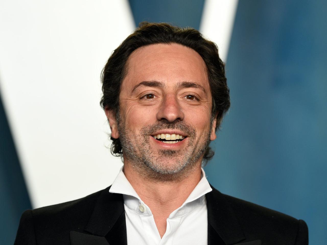 Close-up of Sergey Brin smiling on the red carpet after the Academy Awards ceremony