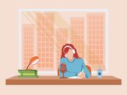 デスクで書き物をする人