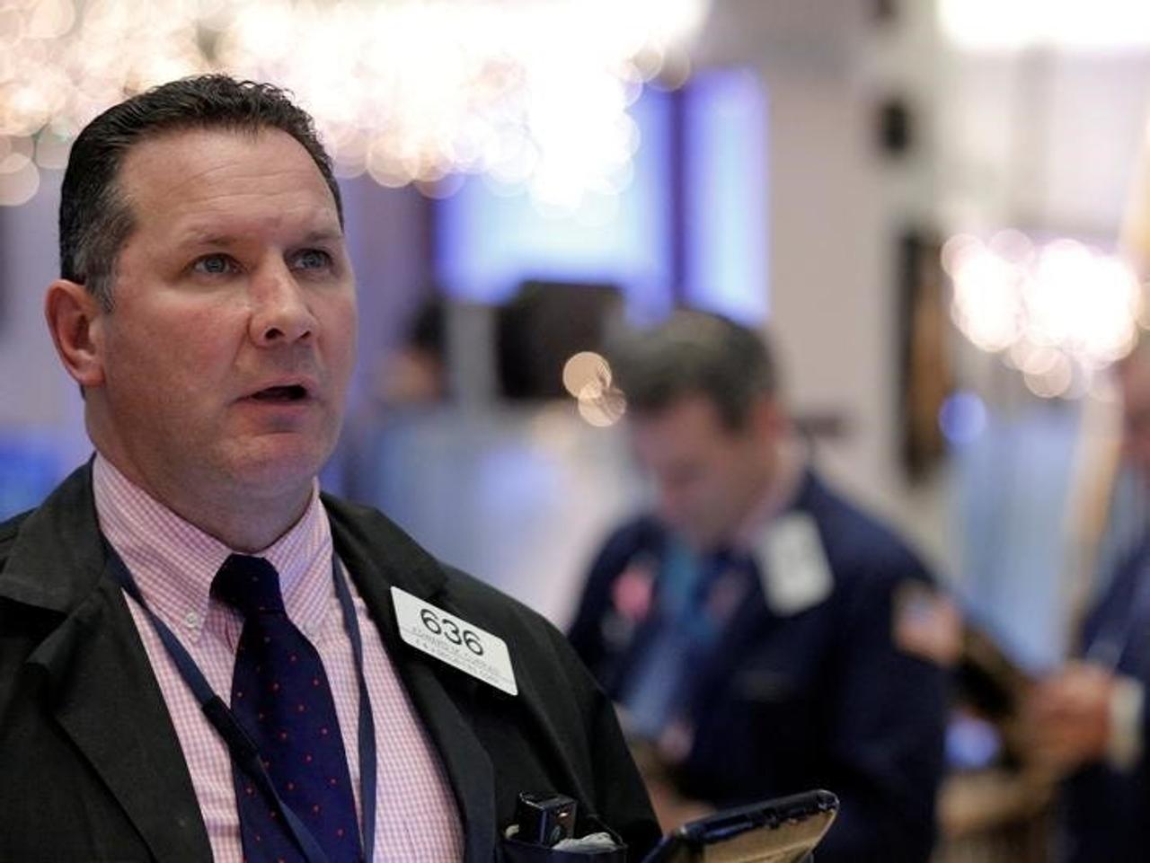 Traders work on the floor of the NYSE