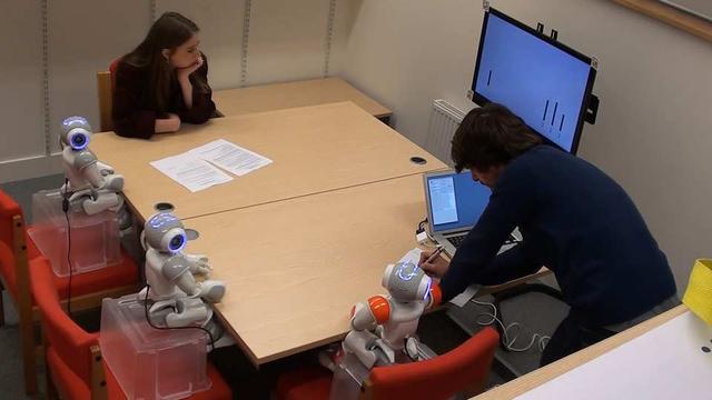 The Asch paradim in action: An adult with three robotic peers.