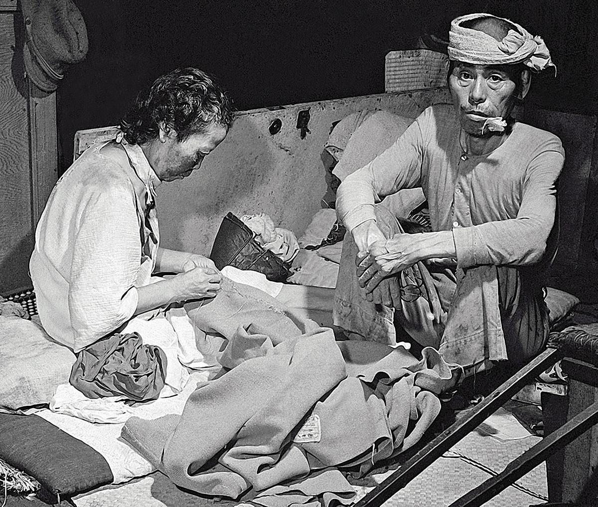 Two victims of the atomic bombing sit in a converted hospital in September 1945.