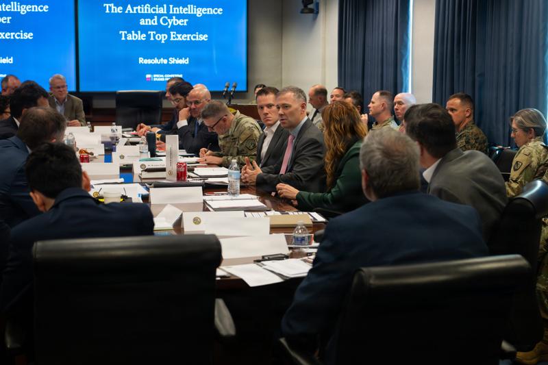 People sit around a table at a conference.