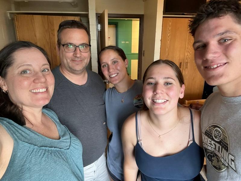 Rebecca Hastings and he family in a college form room