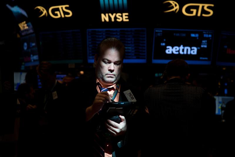 NYSE trader looking at a screen in the dark