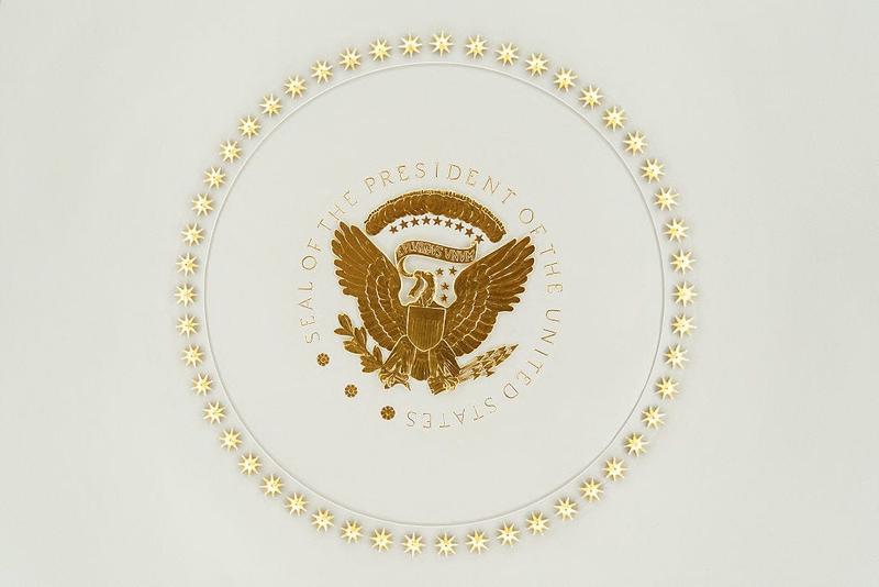 The seal of the president covered in gold in the Oval Office.