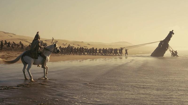 Soldier on horse looking at men lift structure in the odyssey