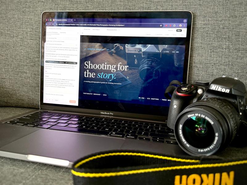 A photo of a MacBook and a Nikon DSLR.