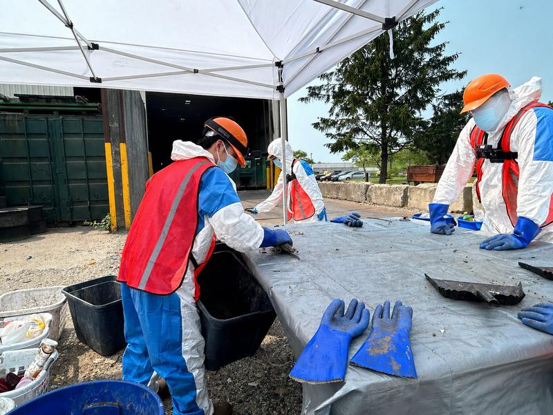 Researchers from the Waste Data & Analysis Center wear GoPro cameras as they sort and characterize municipal solid waste.