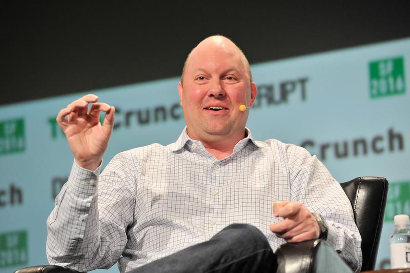 Marc Andreessen is sitting on a black leather chair onstage. He's wearing a white button-up shirt with a gray window pane pattern.