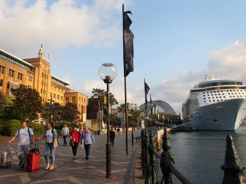 Passengers disembark the Royal Carribbean cruise ship 'Ovation of the Seas' on its return to Circular Quay in Sydney on December 16, 2019 in Sydney, Australia. Several of the ship's passengers were amongst the tourists killed at White Island when a volcano erupted on December 9, 2019, with 16 people now confirmed deceased