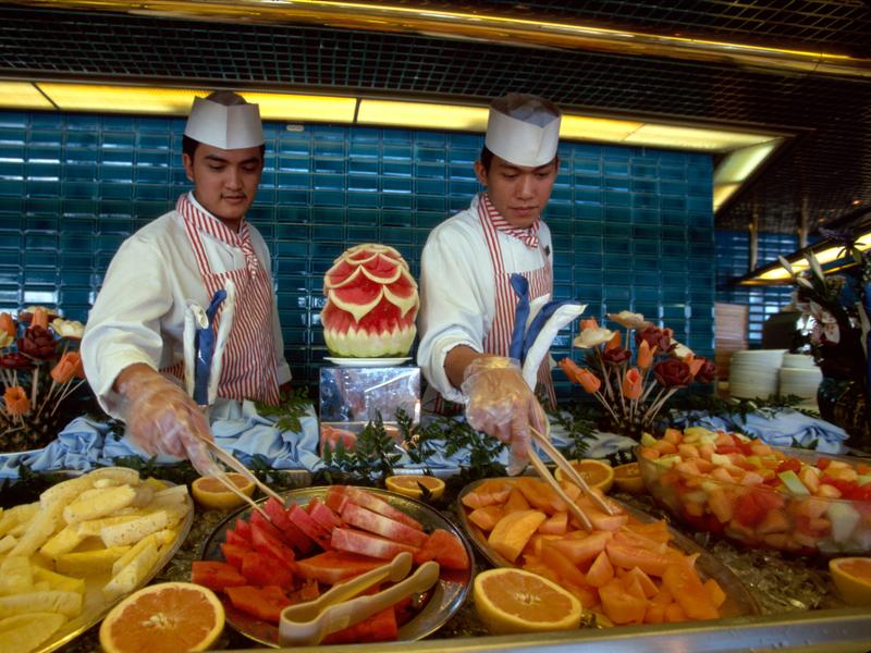 Chefs sand servers at cruise ship Buffet.