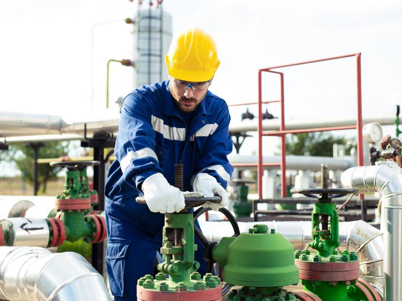 Worker with refinery equipment