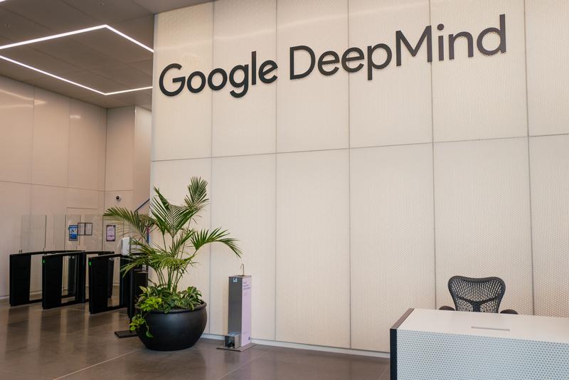 An office lobby with a Google DeepMind sign in dark gray.