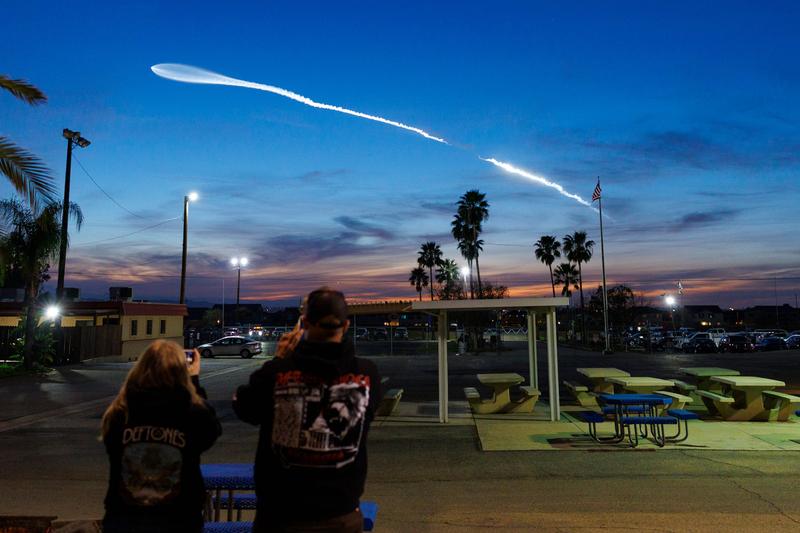 Onlookers attending take pictures of a clear view of the SpaceX Falcon 9 on February 14, 2026, in Perris, California.