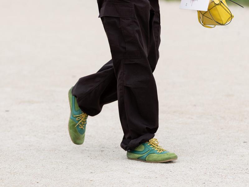 A man wears suede sneakers during Paris Fashion Week.