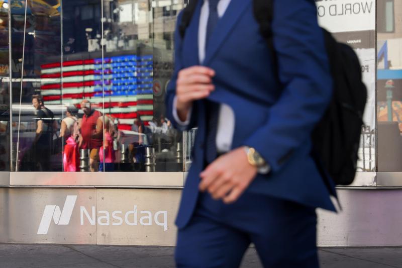 A man walks past the Nasdaq MarketSite in New York
