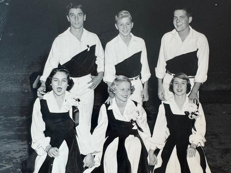 A black and white image of a high school cheerleader team from the 1950s.