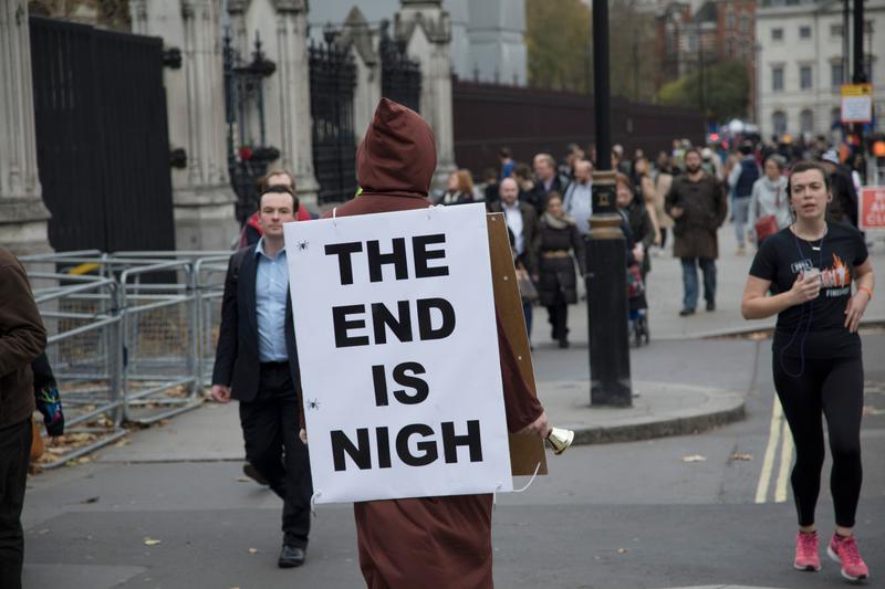 Doom, man with sign that says The End Is Nigh